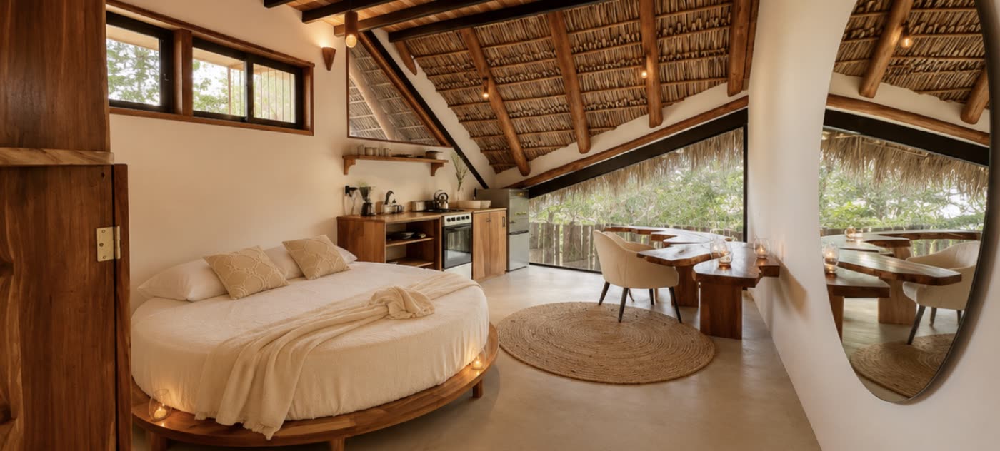 A round bed beneath the thatch in one of the lofts